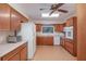 Bright kitchen with wood cabinets, white appliances, and a view of the backyard at 735 Se 22Nd Ave, Ocala, FL 34471