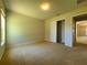 Well-lit bedroom with carpet and a double door closet at 5598 Sw 39Th St, Ocala, FL 34474