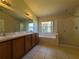 Bathroom boasts double sinks, tub, shower, and tiled floor at 5598 Sw 39Th St, Ocala, FL 34474