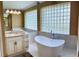 Spa-like bathroom with a free-standing tub, walk-in shower, and dual vanities at 9029 Laurel Ridge Dr, Mount Dora, FL 32757