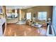 Open living room with hardwood floors and view into kitchen at 9029 Laurel Ridge Dr, Mount Dora, FL 32757