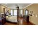 Spacious main bedroom with a large bed, hardwood floors, and plenty of natural light at 9029 Laurel Ridge Dr, Mount Dora, FL 32757