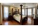 Main bedroom with hardwood floors, large windows, and four-poster bed at 9029 Laurel Ridge Dr, Mount Dora, FL 32757