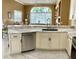 Modern kitchen with white cabinets, granite counters and sink at 9029 Laurel Ridge Dr, Mount Dora, FL 32757