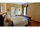 Comfortable guest bedroom with a queen-size bed and hardwood floors at 9029 Laurel Ridge Dr, Mount Dora, FL 32757