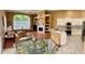 Open concept kitchen and dining area with granite counters and stainless steel appliances at 9029 Laurel Ridge Dr, Mount Dora, FL 32757
