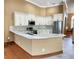 Modern kitchen with white cabinets and granite countertops at 9029 Laurel Ridge Dr, Mount Dora, FL 32757