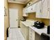 Convenient laundry room with cabinets, a washer, dryer, and workspace at 9029 Laurel Ridge Dr, Mount Dora, FL 32757