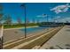 Tennis court with seating area and lights at 5237 Nw 34Th St, Ocala, FL 34482