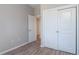 Simple bedroom with wood-look flooring, double doors to closet, and an additional door at 5237 Nw 34Th St, Ocala, FL 34482