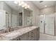 Modern bathroom with a double vanity, granite countertops, and a glass-enclosed shower at 5237 Nw 34Th St, Ocala, FL 34482