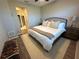 Main bedroom with a king-size bed, ceiling fan, and access to the en-suite bathroom at 5237 Nw 34Th St, Ocala, FL 34482