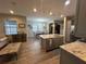 Open kitchen features granite countertops, stainless steel appliances, and an island at 5237 Nw 34Th St, Ocala, FL 34482