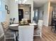 Dining room features a round wooden table with four beige chairs and a view into the kitchen and wine bar at 5237 Nw 34Th St, Ocala, FL 34482
