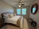 Spacious main bedroom with a king-size bed, large windows, and a ceiling fan at 5237 Nw 34Th St, Ocala, FL 34482