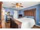 Bedroom with a wooden bed frame and ceiling fan at 8083 Se 62Nd Loop, Ocala, FL 34472