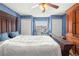 Bedroom with a wooden bed frame and ceiling fan at 8083 Se 62Nd Loop, Ocala, FL 34472