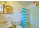 Bathroom with shower/tub combo, blue striped shower curtain and linoleum floor at 2429 Cr 451, Lake Panasoffkee, FL 33538