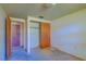 Empty bedroom with wood closet doors and access to another room at 2429 Cr 451, Lake Panasoffkee, FL 33538