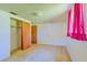 Empty bedroom with wood closet doors and carpeted floor at 2429 Cr 451, Lake Panasoffkee, FL 33538