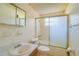 Small bathroom with shower/tub combo and mirrored medicine cabinet at 2429 Cr 451, Lake Panasoffkee, FL 33538