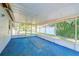 Empty screened porch with blue carpet at 2429 Cr 451, Lake Panasoffkee, FL 33538