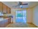 Kitchen features wood cabinets, sliding glass doors, and linoleum floor at 2429 Cr 451, Lake Panasoffkee, FL 33538