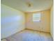 Empty bedroom with window and carpeted floor at 2429 Cr 451, Lake Panasoffkee, FL 33538