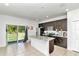 Modern kitchen featuring dark brown cabinets, granite countertops, and a kitchen island at 6839 Sw 149Th Lane Rd, Ocala, FL 34473