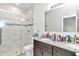 Modern bathroom with double vanity, granite countertops, and a glass shower at 6839 Sw 149Th Lane Rd, Ocala, FL 34473