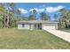 Single-story home with a two-car garage and grey exterior at 6839 Sw 149Th Lane Rd, Ocala, FL 34473