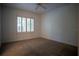 Bright bedroom with window and ceiling fan at 5038 Se 6Th Ave, Ocala, FL 34480
