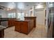 Island kitchen with granite countertops and wood cabinetry at 5038 Se 6Th Ave, Ocala, FL 34480