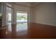 Spacious living room with hardwood floors and pool view at 5038 Se 6Th Ave, Ocala, FL 34480