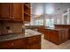 View of kitchen with granite counters, wood cabinets, and stainless steel appliances at 5038 Se 6Th Ave, Ocala, FL 34480