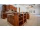 Island kitchen with wood cabinets, granite countertops and open shelving at 5038 Se 6Th Ave, Ocala, FL 34480