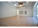 Spacious Gathering room with tile floors, built-in shelving, and access to pool area at 5038 Se 6Th Ave, Ocala, FL 34480