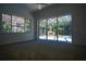 Bright bedroom with carpeting and sliding glass doors leading to the pool area at 5038 Se 6Th Ave, Ocala, FL 34480