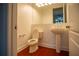 Clean bathroom with pedestal sink and wood flooring at 5038 Se 6Th Ave, Ocala, FL 34480