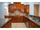 Kitchen with granite countertops, wood cabinets, and gas cooktop at 5038 Se 6Th Ave, Ocala, FL 34480