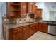 Kitchen detail showing gas cooktop, granite counters, and wood cabinets at 5038 Se 6Th Ave, Ocala, FL 34480