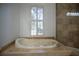 Relax in this luxurious bathroom with a soaking tub at 5038 Se 6Th Ave, Ocala, FL 34480