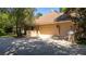 Three-car garage with paver driveway and stone accents at 5038 Se 6Th Ave, Ocala, FL 34480