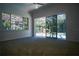 Bright bedroom with carpeting and sliding glass doors leading to the pool area at 5038 Se 6Th Ave, Ocala, FL 34480