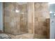 Large shower with glass enclosure and beige tile at 5038 Se 6Th Ave, Ocala, FL 34480