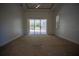Main bedroom with sliding glass doors and pool view at 5038 Se 6Th Ave, Ocala, FL 34480