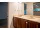 Double vanity bathroom with wood cabinets and beige countertops at 5038 Se 6Th Ave, Ocala, FL 34480