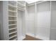 Bright walk-in closet with custom shelving and rods at 5038 Se 6Th Ave, Ocala, FL 34480