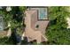 House with pool and screened enclosure, surrounded by trees at 5038 Se 6Th Ave, Ocala, FL 34480