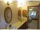 Bathroom with double vanity and large mirror at 16789 Se 69Th Ln, Ocklawaha, FL 32179